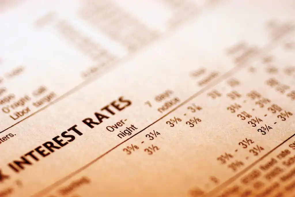 A close-up of a financial newspaper or report showing a table with INTEREST RATES as the heading, listing various rates and terms such as Overnight, 7 days, and numerical percentage values.