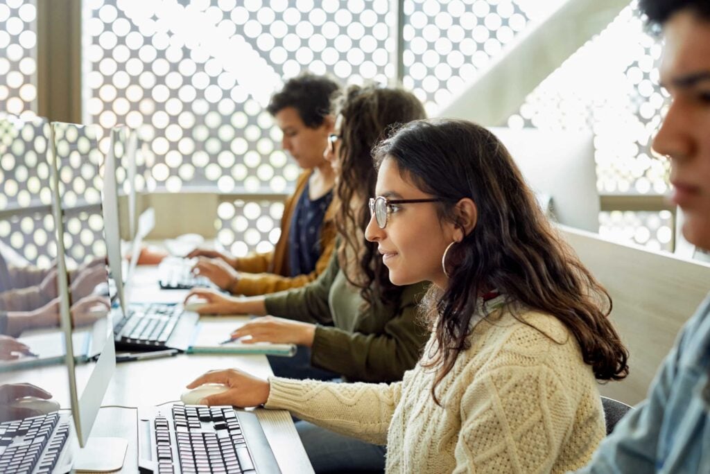 Four Young Adults Working Computers