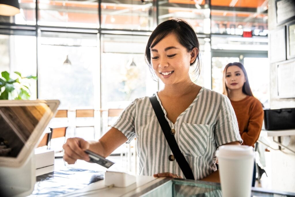Woman Using Credit Card Coffee Shop