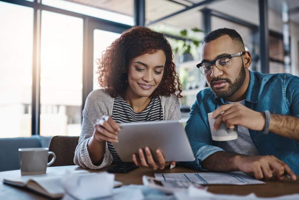 Couple Reviewing Their Finances To See If They Pay Off Their Credit Cards In Full If Their Credit Will Go Up